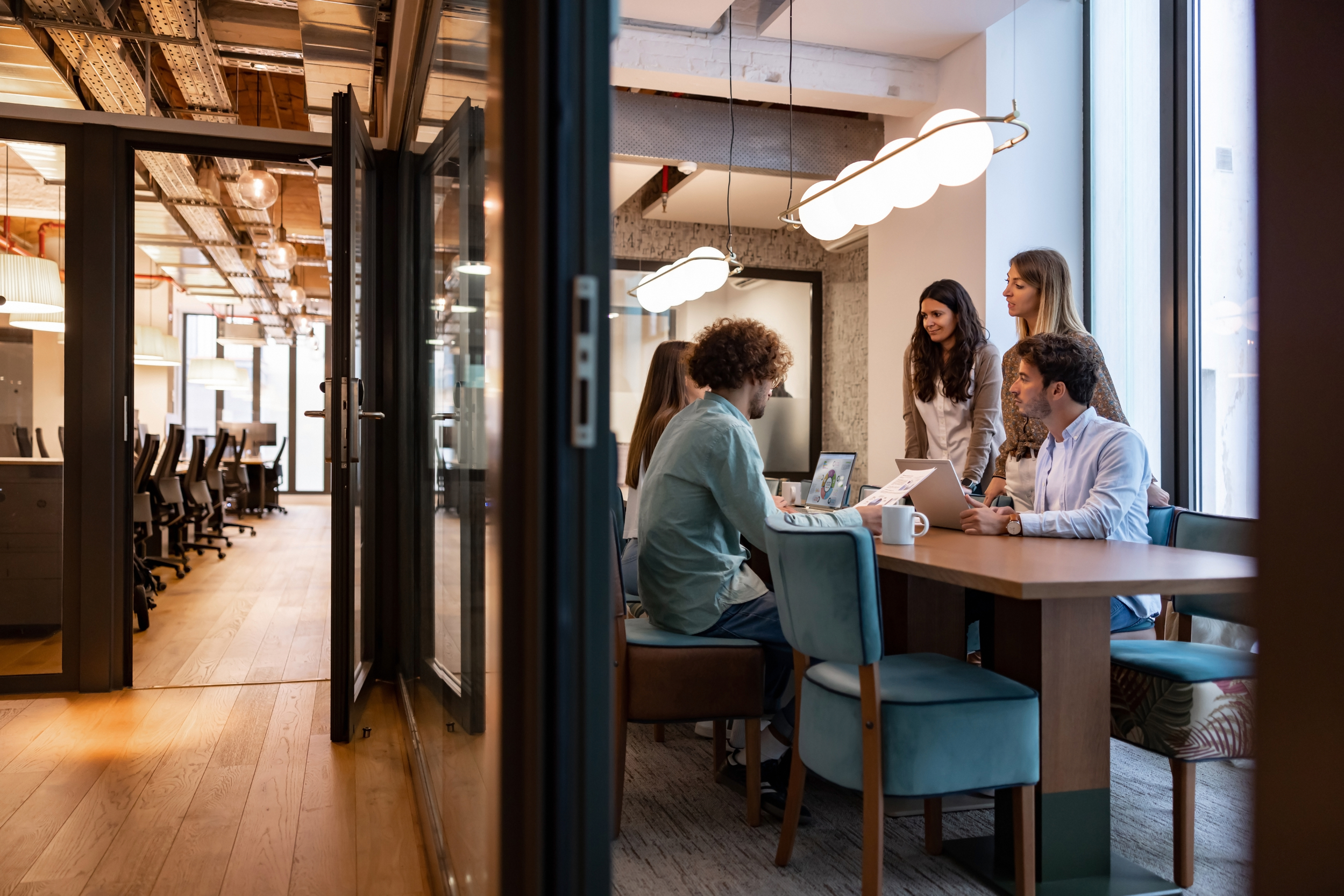 Employee meeting around desk.