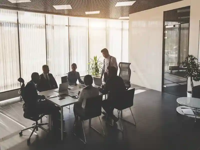 A team of young businessmen working and communicating together in an office.