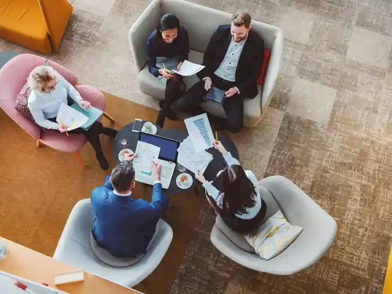 Group of business people in office cafeteria.