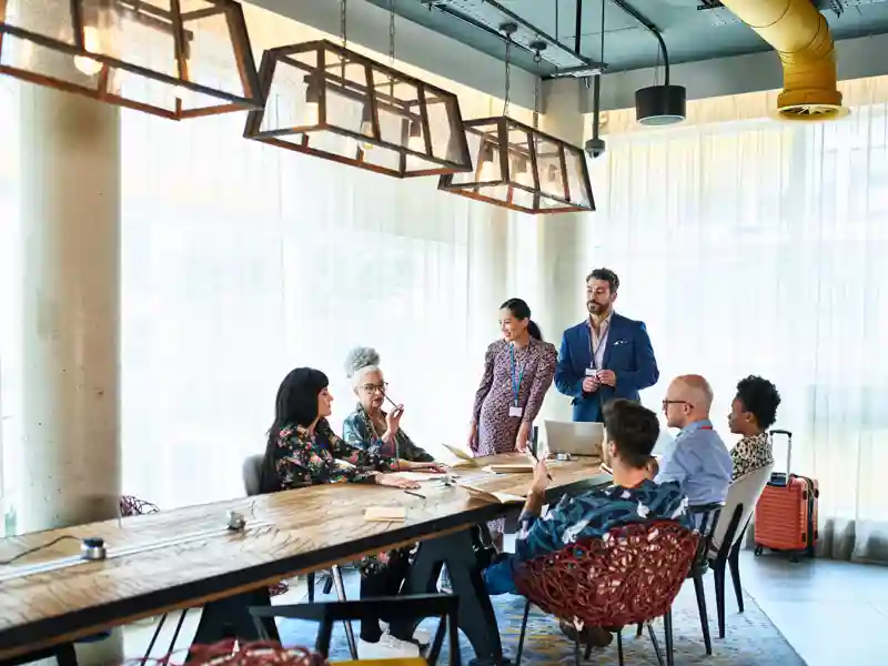 Diverse multi racial business colleagues at meeting table.